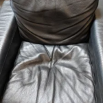 The same seat before restoration, showing worn and damaged covering
